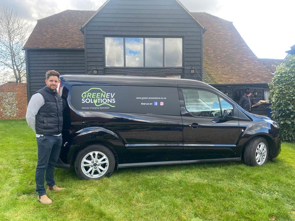Redlec at work: the team with their van outside a timber-clad barn